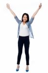 Joyous Female Raising Arms In Excitement Stock Photo