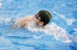 Man Swims In Swimming Pool Stock Photo