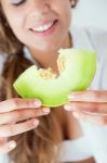 Young Woman In Underwear Eating Melon. Isolated On White Stock Photo