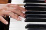 A Woman Playing Piano Stock Photo