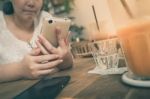 Woman Using Phone In Cafe Stock Photo