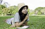 Woman Thinking Hard Studying Outside Stock Photo