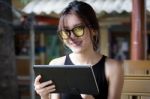 Portrait Of Thai Adult Student University Beautiful Girl Using Her Tablet Stock Photo