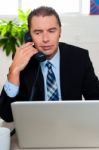 Man In Formal Attire Talking On The Phone Stock Photo