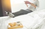 Woman Reading Book Or Newspaper And Drinking Coffee Breakfast On Stock Photo