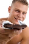 Muscular Man Offering Chocolate Stock Photo