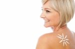 Woman With Sunscreen Lotion On Her Back Stock Photo