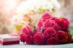 Red Roses Flowers With Valentine Festival Gift And Beautiful Blur Bouquet Background Stock Photo