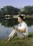 Happy Woman On Grass Listening To Music Stock Photo