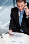 Businessman Communicatng On Phone Stock Photo