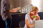 Couple At Home Using Laptop Stock Photo