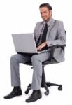 Business Man Sitting With Laptop And Smiling Stock Photo