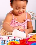 Kid Playing At Pouring Cup Of Tea Stock Photo