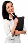 Female Executive Holding Business File And Pen Stock Photo