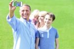 Father Clicking Family Selfie, Outdoors Stock Photo