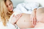 Young Pregnant Woman Resting On Sofa Stock Photo