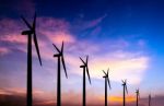 Wind Turbine Silhouette On Colorful Sunset Stock Photo