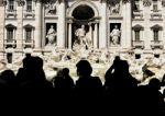 Trevi Fountain And Tourists Shooting Stock Photo