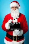 Bespectacled Santa Holding A Clapperboard Stock Photo