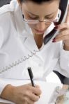 Lady Doctor Talking Over Landline Stock Photo