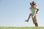 Young Man Piggy Backing Stock Photo