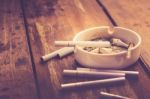 Cigarette With Ashtray On Wood Table Stock Photo