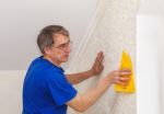 Elderly Worker Smoothing Wallpaper Stock Photo