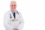 Senior Doctor Holding Clipboard Stock Photo