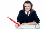 Smiling Schoolgirl Holding Pencil Stock Photo