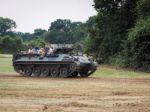 People Enjoying A Ride In An Armoured Car At Dunsfold Airfield Stock Photo