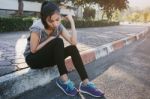 Woman Relaxing After Sports. Hipster Student In The City Park Stock Photo