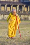 An Unidentified Old Buddhist Female Monk Dressed In Orange Toga Stock Photo