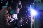 Worker Welding And Bright Sparks Stock Photo