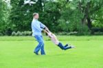 Playful Father And Daughter Having Fun In Garden Stock Photo