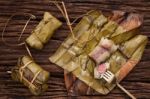 Khao Tom Mat - Thai Dessert - Sticky Rice, Banana And Black Beans Wrapped In Banana Leaf Stock Photo