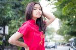 Portrait Of Thai Teen Beautiful Girl In Chinese Dress, Relax And Smile Stock Photo