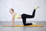 Young Woman Stretching Before Fitness Exercises On A Mat In A Gy Stock Photo