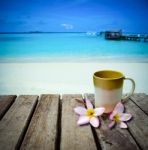 Coffee Cup On Old Wood Table Placed On The Beach Stock Photo