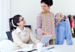 Two Young Businesswomen Working With Digital Tablet In Her Offic Stock Photo