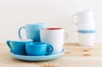 Blue Cups And White Mug On Wood Table Stock Photo