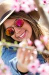 Beautiful Young Woman With Flowers In The Field Stock Photo