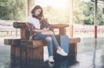 Traveler Girl Using Tablet With A Luggage Sitting And Waiting Fo Stock Photo