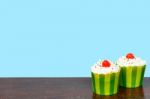 Colorful Cupcakes On A Wooden Background Stock Photo