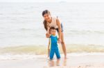 Mom And Son Chill On The Beach Stock Photo