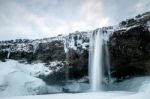 View Of Seljalandfoss Waterfall In Winter Stock Photo