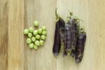 Violet Peas On A Wooden Desk Stock Photo