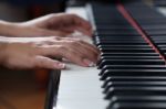 A Woman Playing Piano Stock Photo