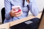 Woman Holding Smartphone In Office Stock Photo