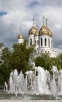 Fountain Near Church With Cloudy Sky Stock Photo