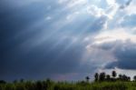 Beam Of Sunlight Behind Dark Clouds Stock Photo